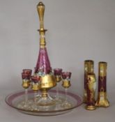 A Venetian ruby and gilt-painted liqueur set with a pair of matching vases and tray