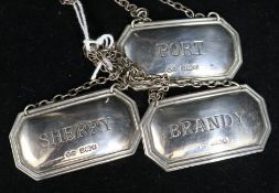 A set of three silver wine labels 'Port', 'Sherry' and 'Brandy'