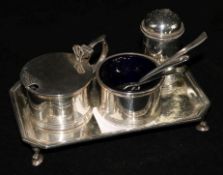 A George V silver three piece condiment set and a matching stand (4)