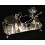 A George V silver three piece condiment set and a matching stand (4)