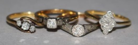 Four assorted 18ct gold and diamond set dress rings.