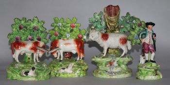 A Walton pottery sheep and lamb spill vase, two Staffordshire pottery cow and calf groups & a