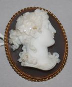 A French 18ct gold mounted oval hardstone cameo brooch, carved with the bust of a lady to