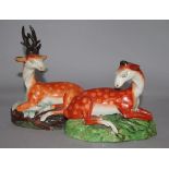 An early 19th century Staffordshire pearlware recumbent stag and a similar doe