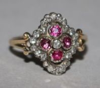 A Victorian style ruby and diamond cluster ring, of quatrefoil shape, size O.