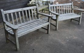 A pair of slatted teak garden benches, W.131cm