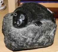 An Inuit carved hardstone model of a seal cub, monogrammed J.G.