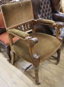 A late Victorian acanthus-carved oak open arm elbow chair