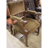 A late Victorian acanthus-carved oak open arm elbow chair