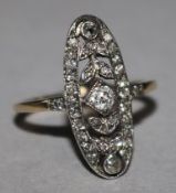 A Victorian style gold and diamond pierced oval cluster ring, size P.