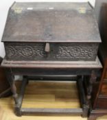An early Victorian carved oak writing slope on stand (a.f.)