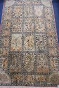 A Persian silk rug woven with shrubs in panels, 153cm x 92cm