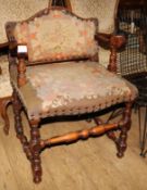 A 1930's Carolean style oak elbow chair, with tapestry upholstery