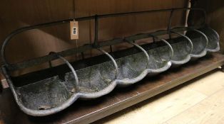 A wrought iron seven stall sheep trough, and a pair of iron firedogs (3) trough W.150cm