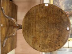 A George III mahogany circular tilt top tea table, on turned pillar and tripod cabriole base, W.