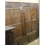 A 17th century oak carved and panelled two door hanging cupboard, W.150cm (a.f.)