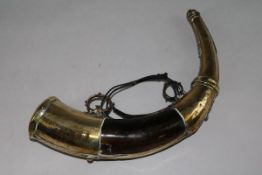 A 19th century Moroccan engraved and pierced brass powder horn