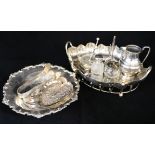 Ten silver items including fruit dish, cream jug and two ring trees, together with a plated dish.