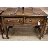 An oak side table, fitted two short drawers W.107cm