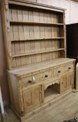 A pine dresser, fitted open shelves, drawers and cupboards, H.209cm