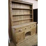 A pine dresser, fitted open shelves, drawers and cupboards, H.209cm