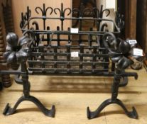 A black painted fire basket and fire dogs, a small black painted kerb and sundry fire accessories,