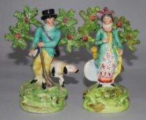 A matched pair of Staffordshire pearlware figures of a sportsman with his dog and a figure of his