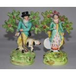 A matched pair of Staffordshire pearlware figures of a sportsman with his dog and a figure of his