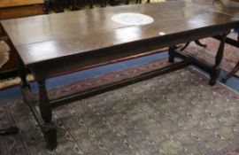 An 18th century style oak refectory table, with turned legs and 'H' writing stretcher, the top inset