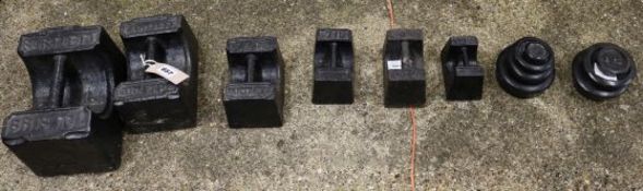 A set of nine black painted weights and six other weights