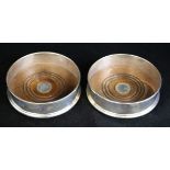 A pair of silver wine coasters with turned wooden bases, London, 1991, 5in.