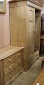 A pine two-door wardrobe, a pine four-drawer chest and a pine-framed rectangular wall mirror,