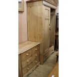 A pine two-door wardrobe, a pine four-drawer chest and a pine-framed rectangular wall mirror,