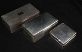 A 1950's engine turned silver cigarette box with gold thumbpiece and two other silver cigarette