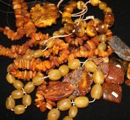 A quantity of mixed amber including jagged necklace, loose fragments and a brooch.