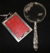A silver-mounted magnifying glass, foliage, bird and mask-embossed (William Comyns) and a silver and