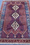 A Persian red ground rug