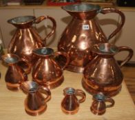 8 copper graduated measuring jugs