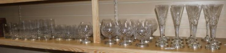 A set of twelve champagne flutes, Brandy balloons, spirit glasses and water glasses and two wine