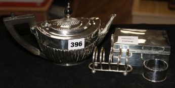 A silver teapot, a cigarette box, a toastrack and a napkin ring gross 22 oz.