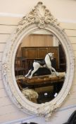 A large painted oval mirror, H.150cm