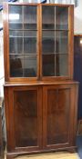 A 19th century mahogany cupboard, with associated glazed two door top W.101cm