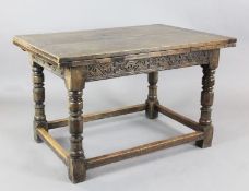 A 17th century style oak draw leaf table, with scroll carved frieze and squared stretchers, W.4ft