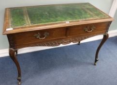 A leather topped two drawer writing table, W.117cm