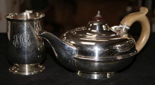 A silver circular flattened teapot and a silver Christening mug