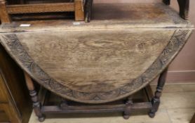 A carved oak gateleg table, W.104cm