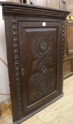 A Victorian carved oak hanging corner cupboard, W.102cm