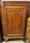 A Georgian oak corner cupboard, W.116cm