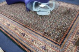 A Persian green ground carpet, 475 x 305cm