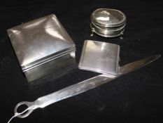 Two silver boxes, a compact and a letter opener.